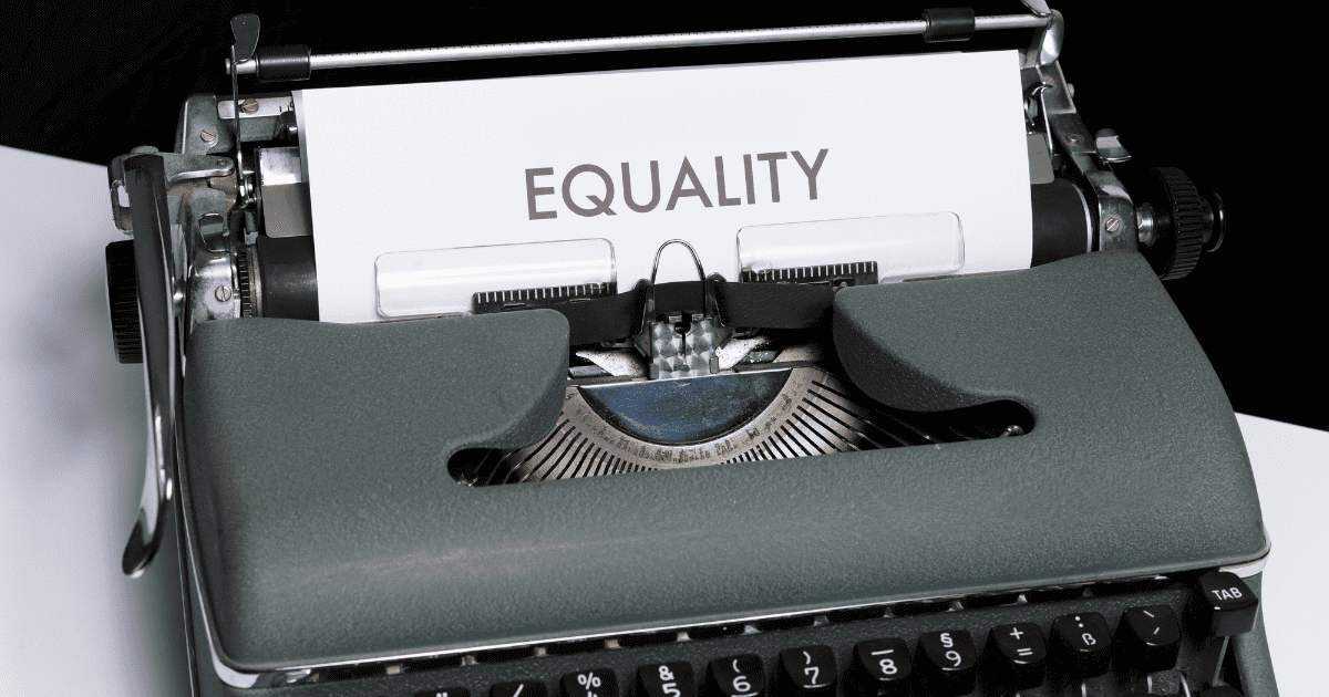 paper in a typewriter with the word "equality" printed out